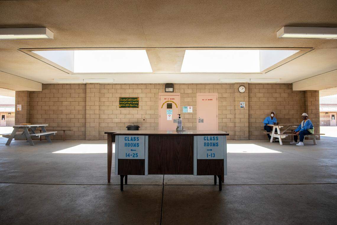 Signs on a desk direct people to classrooms at Valley State Prison. Gov. Gavin Newsom is accelerating plans to reimagine life inside state institutions, starting with Chowchilla.