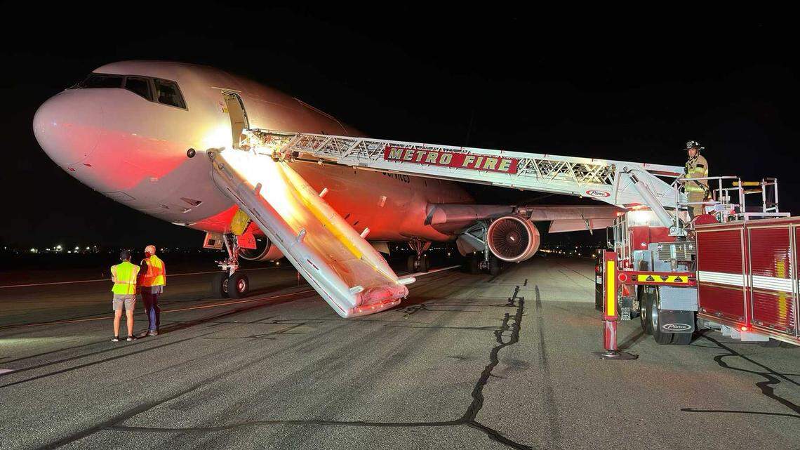 Firefighters are seen on the tarmac of Mather Airport on Wednesday, Sept. 4, 2024, following the emergency landing of a UPS freighter jet. No injuries were reported after the pilots reported smoke in the cockpit before their diversion.