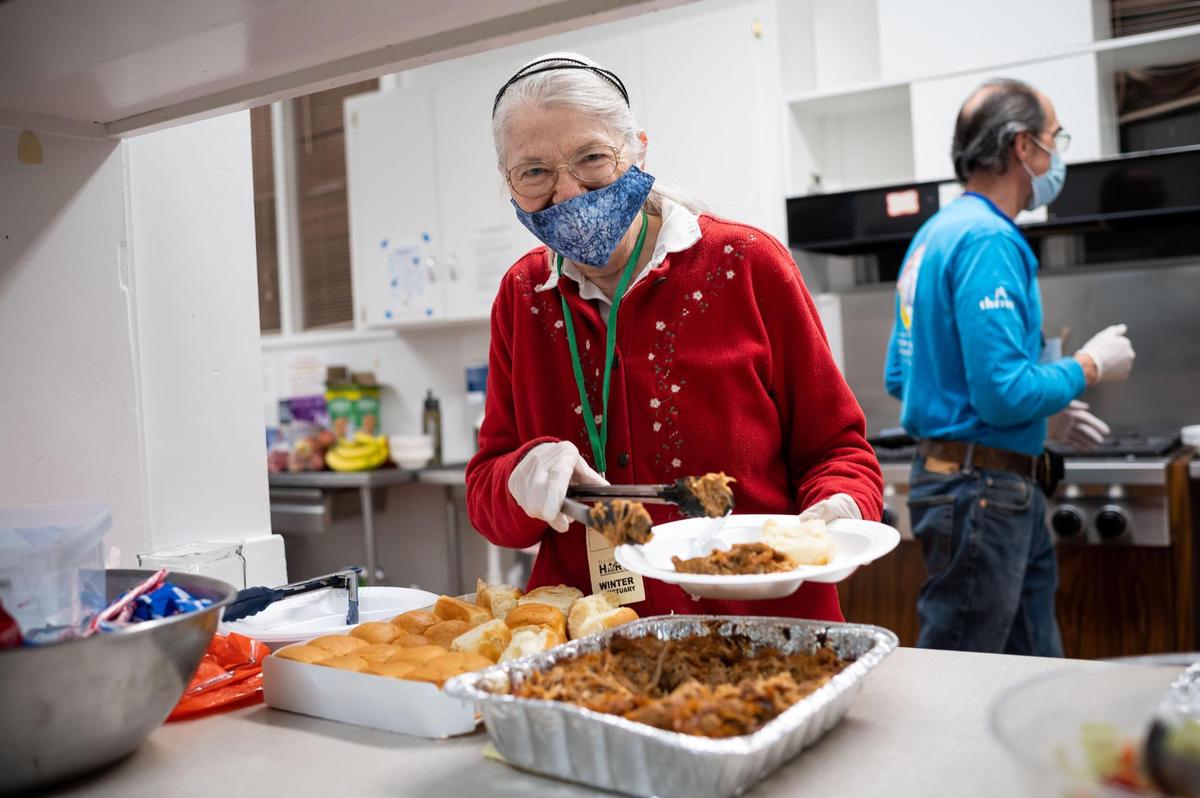 Bonnie McGraw volunteers to serve food at the Elk Grove United Methodist Church Overnight Warming Center on Friday, Dec. 10, 2021, at 8986 Elk Grove Blvd.