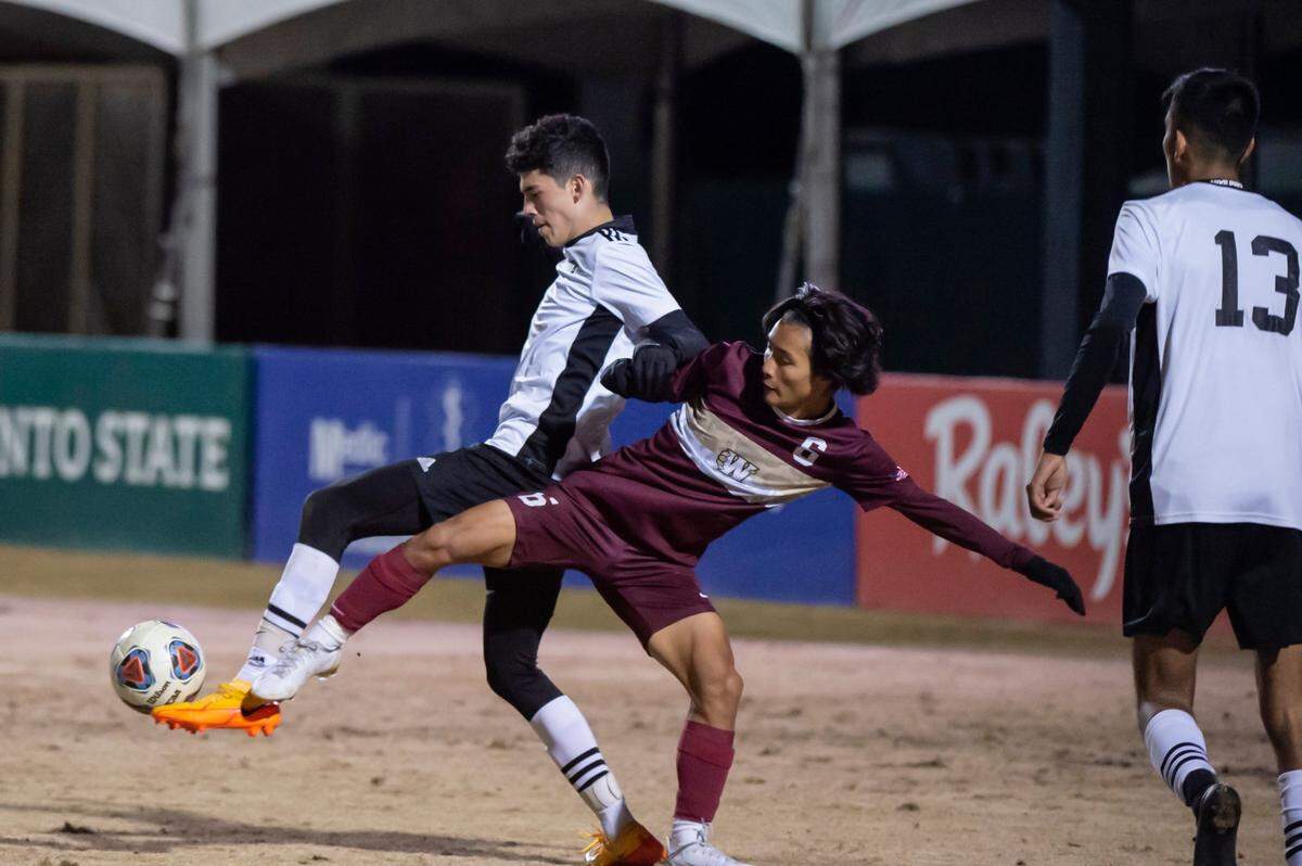 The Whitney Wildcats’ Daniel Yoon (6) battles for possession of the ball with the Modesto Panthers’ Adrian Silva (16) during the second half at the CIF Sac-Joaquin Division I boys soccer championship on Thursday, Feb. 24, 2022, at Heart Health Park in Sacramento. Yoon scored one goal. The Wildcats won 5-0.