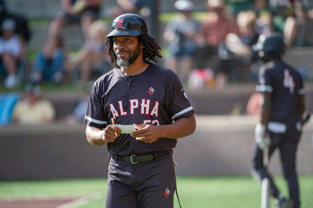 Alpha Charter head coach Harvey Hargrove walks to coach at third base in the top of the fifth inning on Thursday at Jesuit High School in Carmichael.