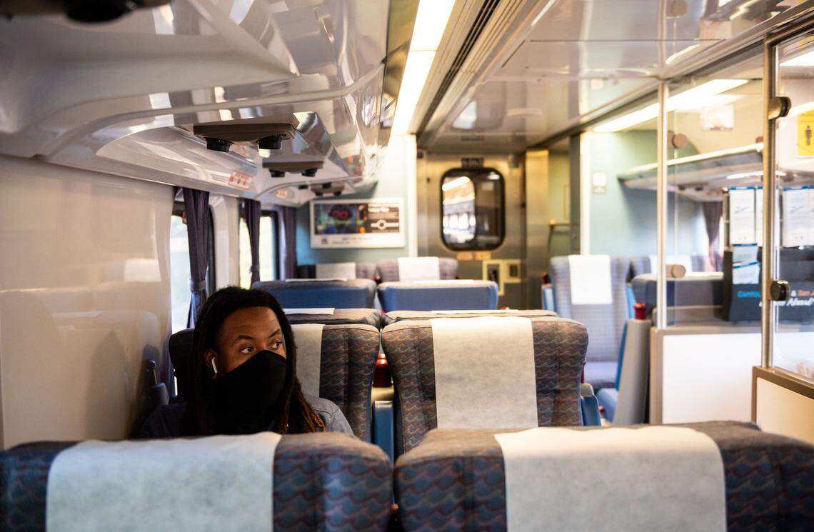 A passenger in 2020 rides in a mostly empty train car to San Franciso from Sacramento.