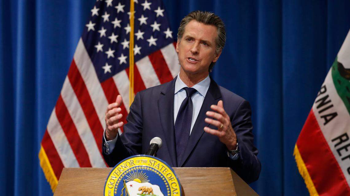 California Gov. Gavin Newsom discusses his revised 2020-2021 state budget during a news conference in Sacramento on Thursday, May 14, 2020. Reflecting the financial hit California is already seeing from the coronavirus, Newsom proposed cutting $6.1 billion from a variety of programs in a state budget he says prioritizes public education, public health and public safety.