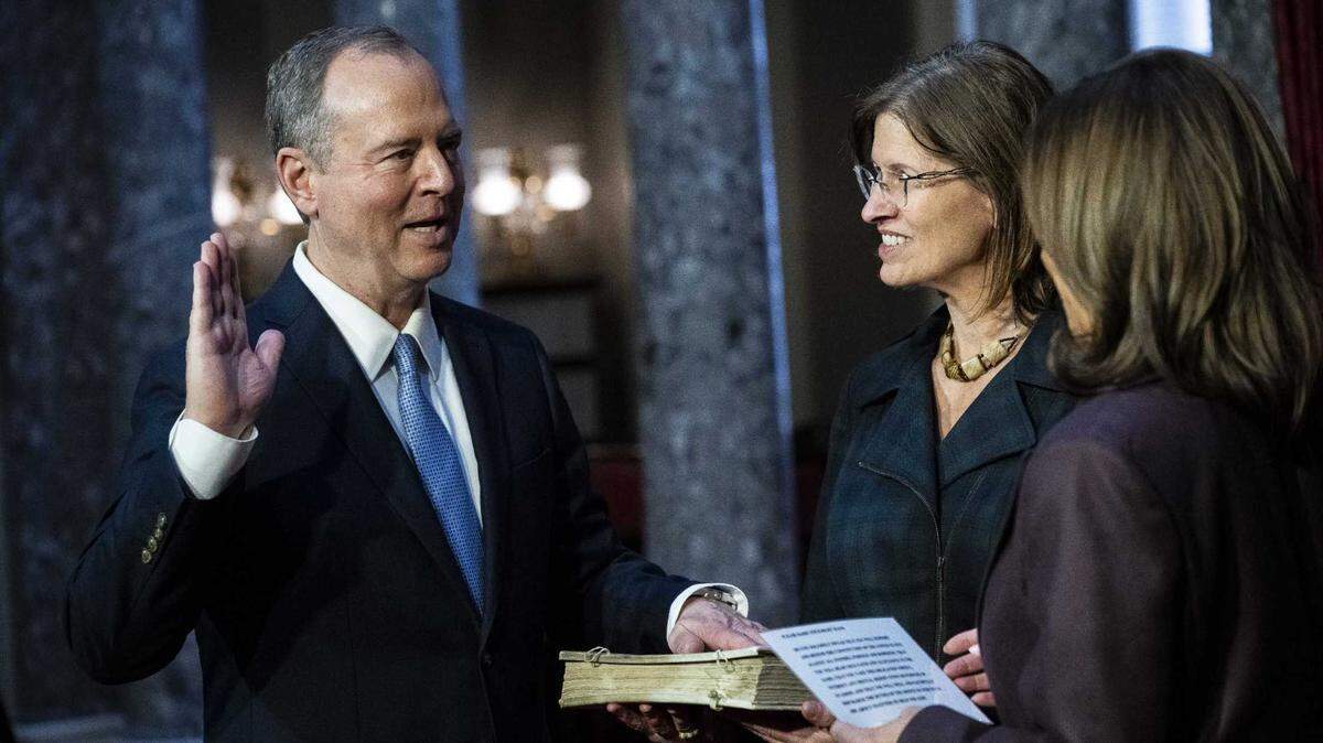 Sen. Adam Schiff takes the oath of office Monday in a private swearing-in ceremony with Vice President Kamala Harris, right, and his wife, Eve Sanderson, in the Old Senate Chamber on Capitol Hill.