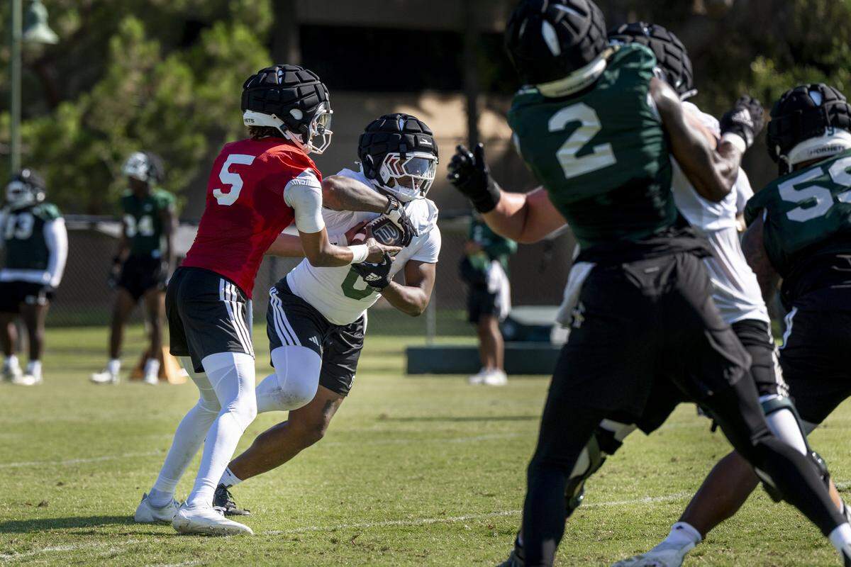 Quarterback Jaden Rashada (5) hands off the ball to Running Back (0) during the first practice of the 2025 season in Sacramento on Friday, August 1, 2025.