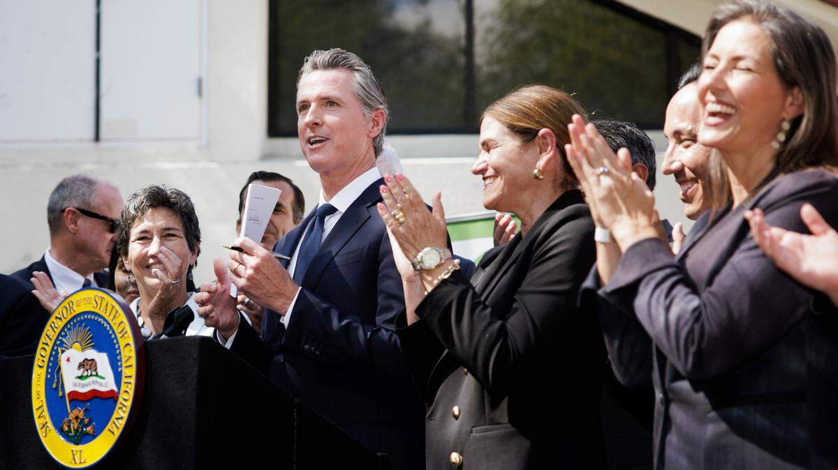 Gov. Gavin Newsom signs legislation establishing the Community Assistance, Recovery and Empowerment Act, in San Jose on Wednesday, Sept. 14, 2022. The CARE program allows family members, first responders and others to ask a judge to draw up a treatment plan for someone diagnosed with certain disorders, including schizophrenia.