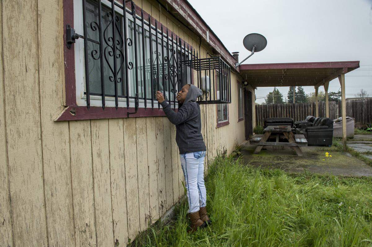 Lashunda Britt, a cousin of Stephan Clark, said he was probably knocking on the window through the bars to alert his grandfather to use his remote to open the garage door when he was fatally shot by police on Sunday.