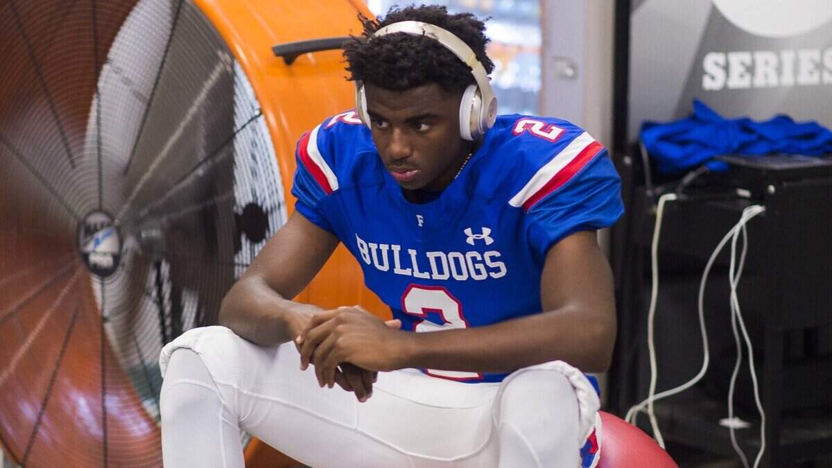 Folsom Bulldogs’ Caleb Nelson gets ready inside the locker room before playing the Jesuit Marauders last season.