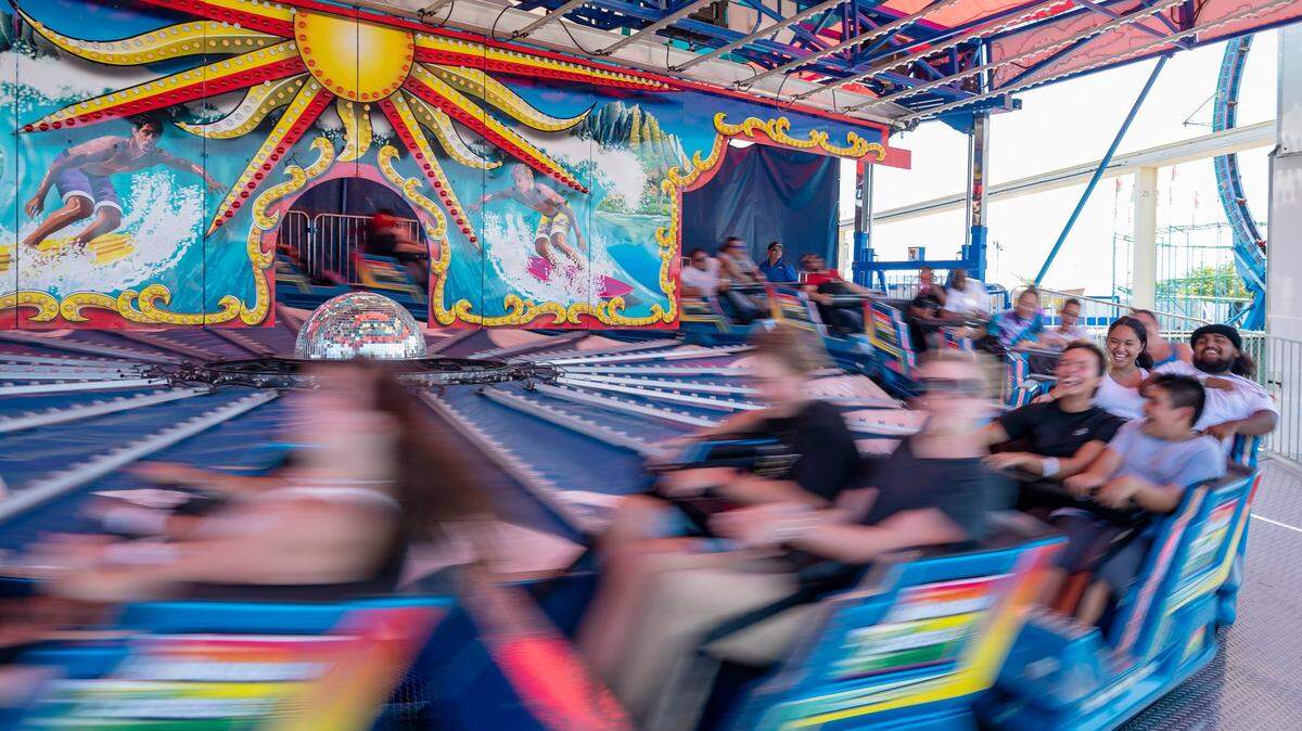 Guests laugh as the Hawaiian Express ride speeds up at the California State Fair on Sunday, July 17, 2022, at Cal Expo.