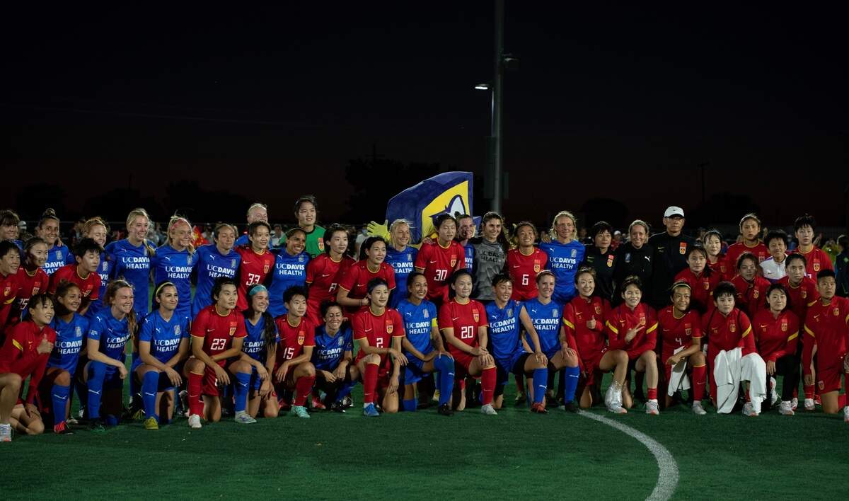 Players from the California Storm and Chinese Women’s National Team gather for a joint team picture after their friendly game at the Davis Legacy Sports Complex on August 6.