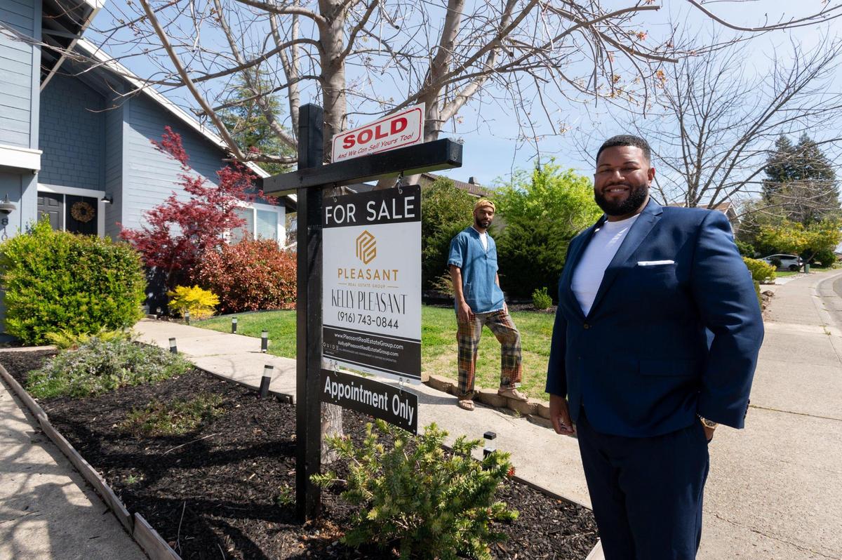 Real estate agent Kelly Pleasant stands in March with homeowner Kenny Franklin at his Orangevale home that recieved seven offers and sold for $35,000 over the listing price.