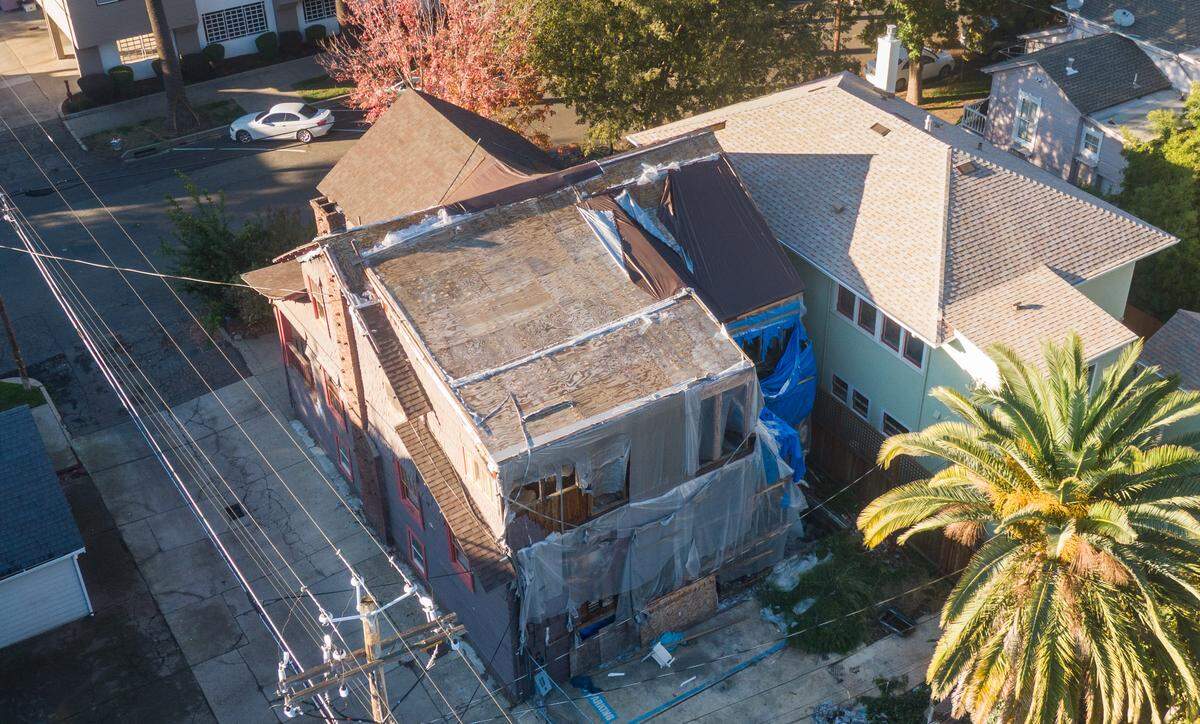 Construction efforts related to damage from a fire a few years ago are visible at a vacant home at 1315 22nd St. in midtown Sacramento on Friday. The city recent sued the owners of the property.