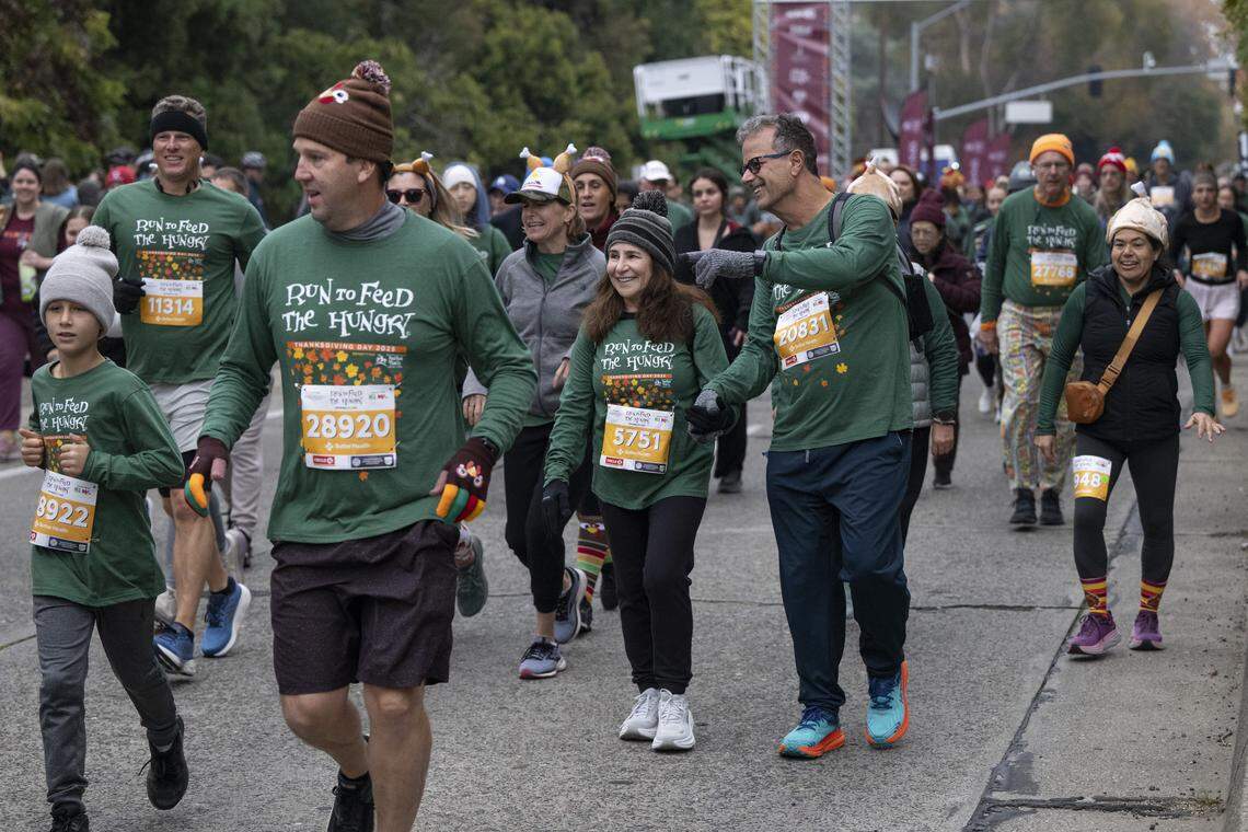 Race participants run in the 10k race during the Run to Feed the Hungry in Sacramento on Thursday, Nov. 27, 2025.