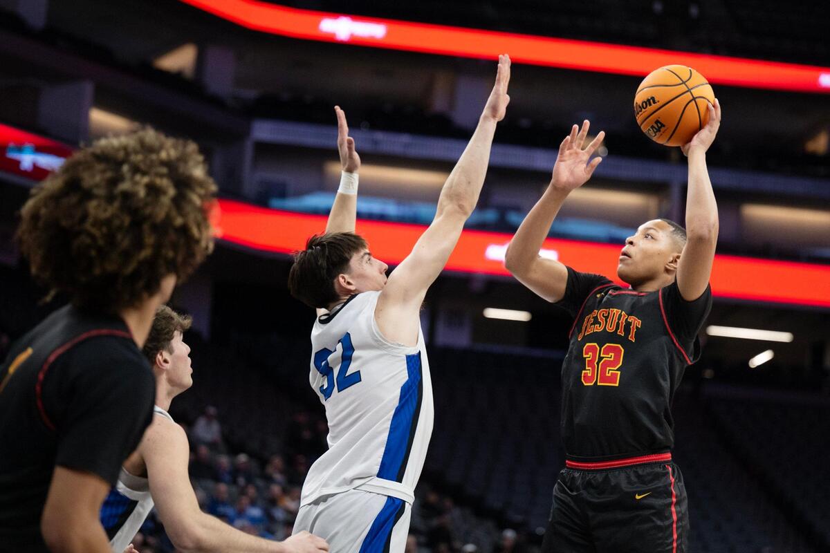 The Jesuit Marauders’ Amaury Mckinney (32) scores a basket over the Rocklin Thunder’s Mark Lavrenov (32) in the CIF Sac-Joaquin Section Division ll championship at Golden 1 Center on Thursday. Both teams will host a NorCal playoff game Tuesday.