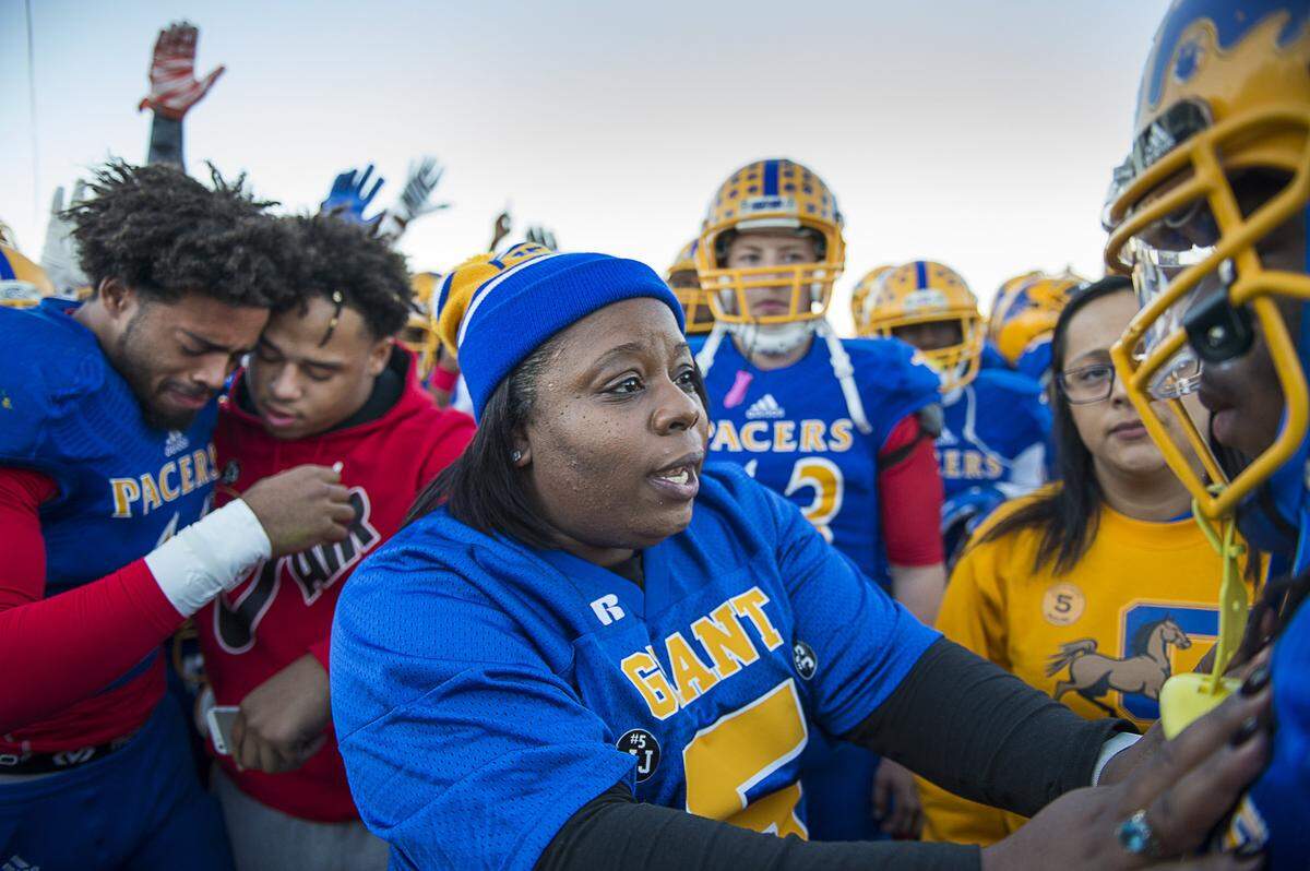 Nicole Clavo offers encouragement to the Grant High football team during a remembrance for her son, Joulon Clavo, at Grant High School Monday November 16, 2015 in Sacramento, Calif.