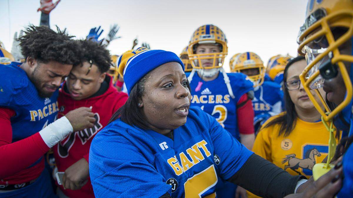 Nicole Clavo offers encouragement to the Grant High football team during a remembrance for her son, Joulon Clavo, at Grant High School on Nov. 16, 2015, a week after he was shot and killed near the campus, hours before a playoff game.