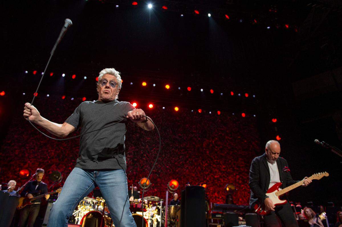 Roger Daltrey, left, whips the microphone in the air while Pete Townshend jams on the guitar as The Who performs in Sacramento on their North American tour Wednesday at the Golden 1 Center.