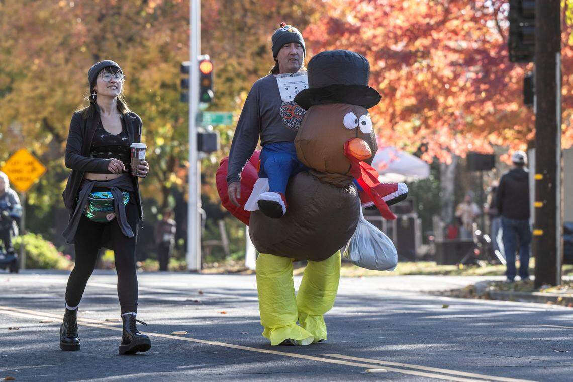 Brittney Bryant, of Rocklin, follows her father James as they participate in the 30th annual Run to Feed the Hungry on Thursday, Nov. 23, 2023, in East Sacramento. 