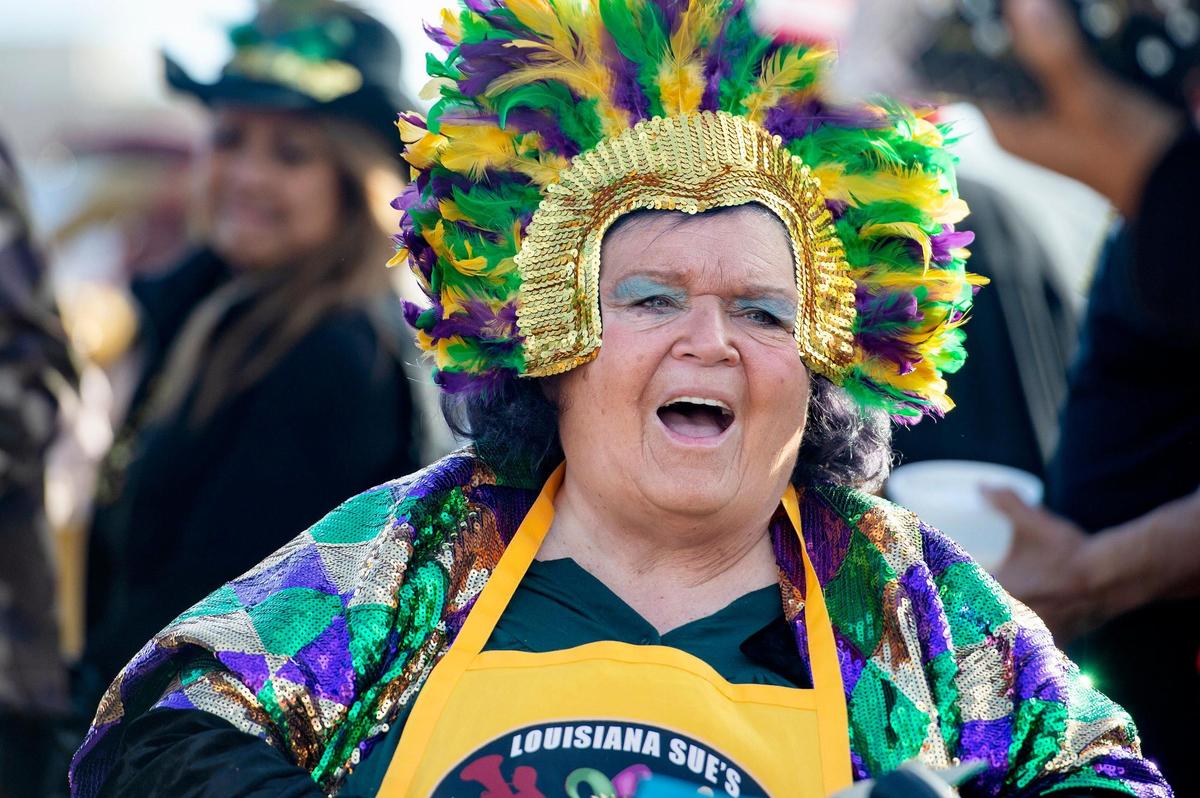 Festival coordinator Louisiana Sue Ramon talks with guests during the Mardi Gras celebration on Sunday, Feb. 19, 2023, in Old Sacramento.