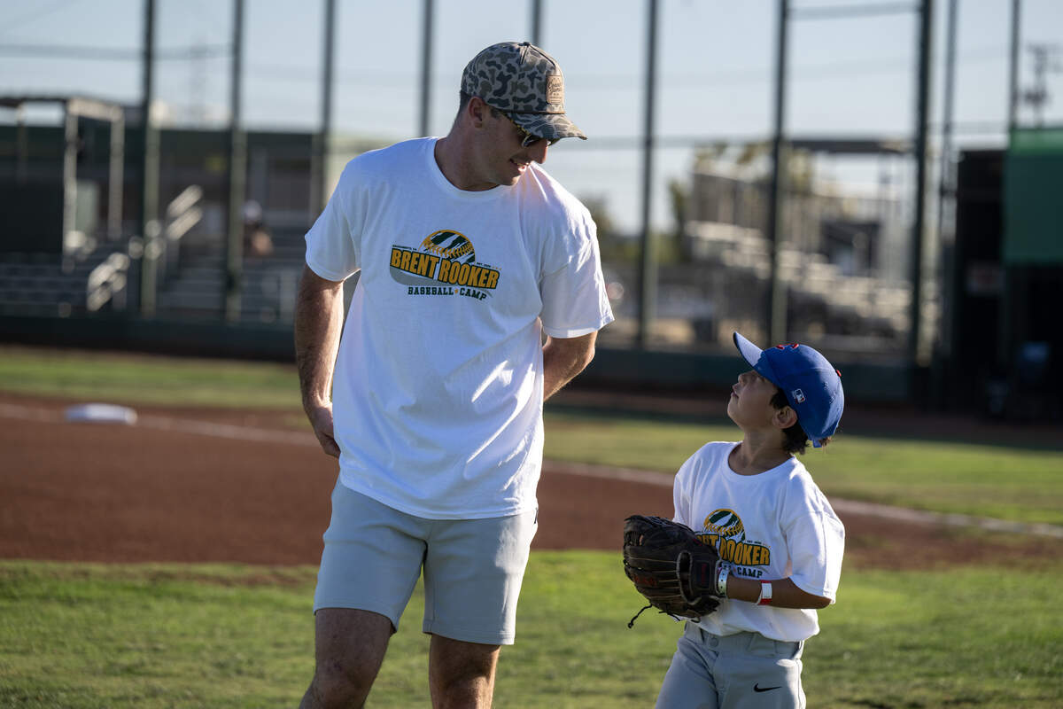 Zack Martin, 8, of Lincoln talks with Athletics player Brent Rooker during his youth sports camp in Sacramento on Thursday at Depot Park.