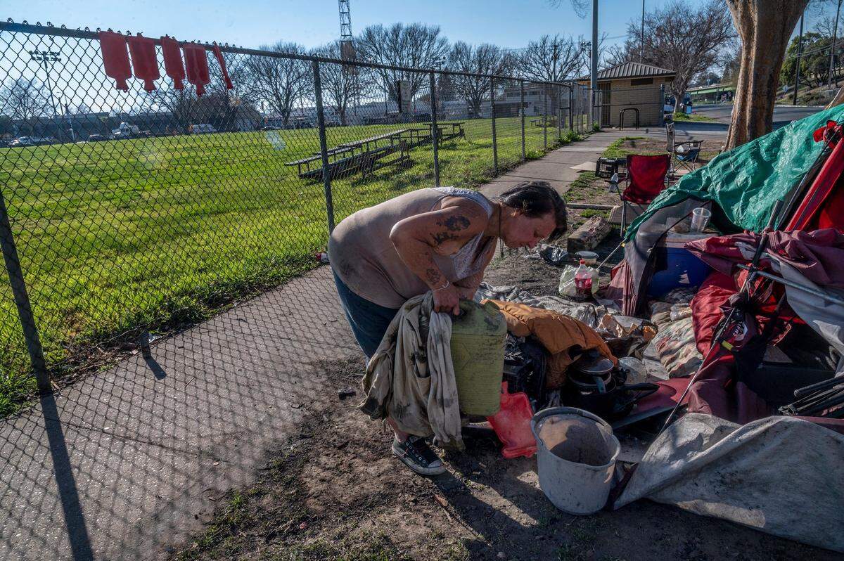Sherry Aday, 46, had just used a makeshift shower of water bottles to wash her hair at her camp on X Street in Sacramento on Thursday. Although she lives near a park with a working restroom and a water fountain, it’s locked so she has to walk to Southside park to use their facilities. She says it’s difficult carrying the big jugs of water.