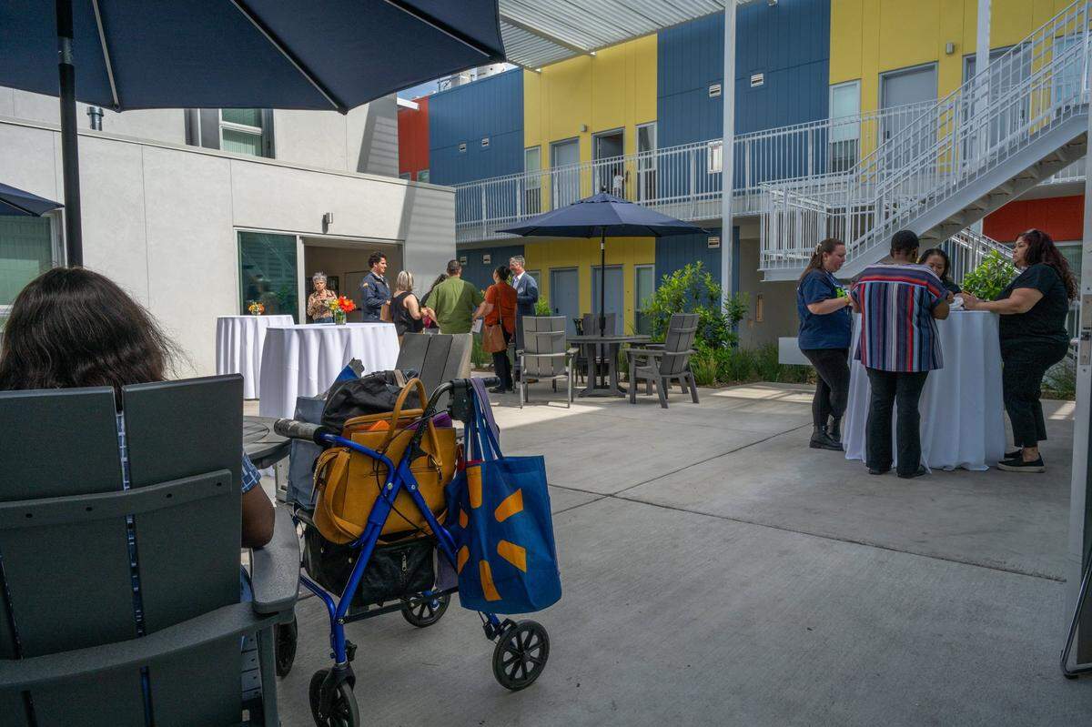 Community members and residents of Northview Pointe’s 67-unit housing complex in North Sacramento celebrate its grand opening in one of its courtyards on Wednesday. All of but one of the units of the permanent supportive housing facility are occupied.