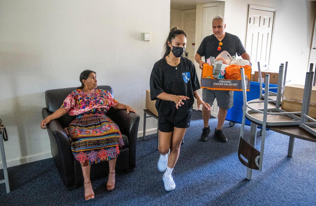 Luisa de Maldonado, left, of Guatemala, watches her granddaughter’s roommate Rosemarie Baldovinos, of El Dorado Hills move into the dorms at Sonoma State with the help of her father Ricardo Baldovinos on Tuesday.