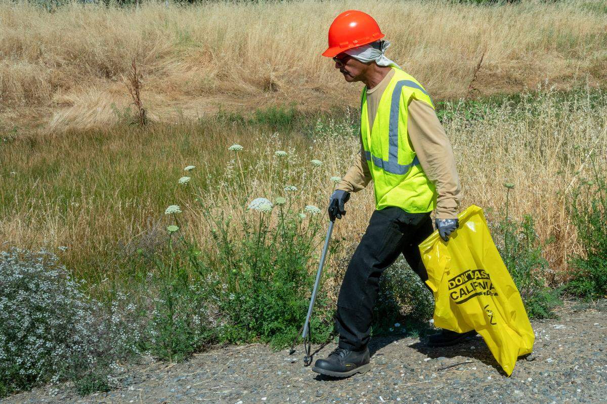 David King picks up trash along Highway 70 near Nicolaus on May 30. Caltrans partners with the Center for Employment Opportunities to provide job training and employment opportunities, particularly for individuals who have been incarcerated.