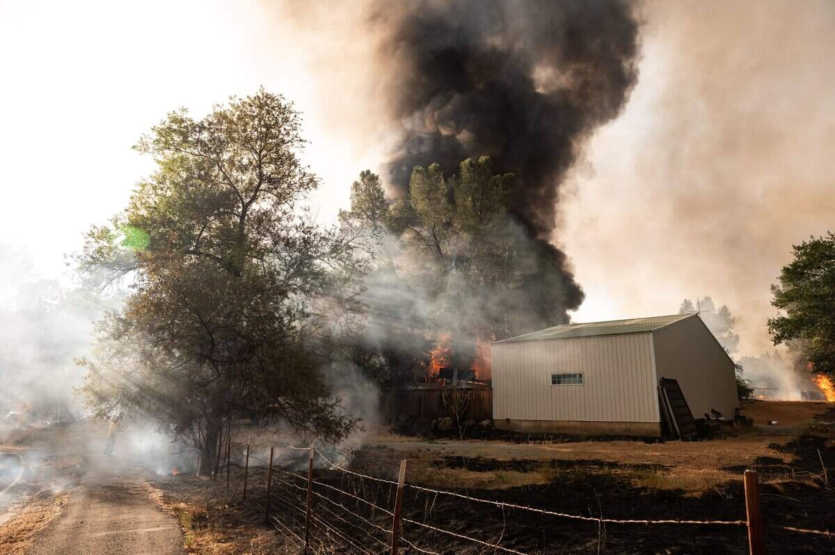 The River Fire burns property and homes Wednesday, Aug. 4, 2021, in Chicago Park, Nevada County