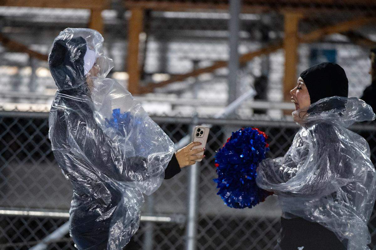 The Folsom Bulldogs cheerleaders enjoy the wind and rain in the first half of the CIF Sac-Joaquin Section Football Playoffs semifinal game against the Inderkum Tigers on Nov. 22, 2024 in Folsom.