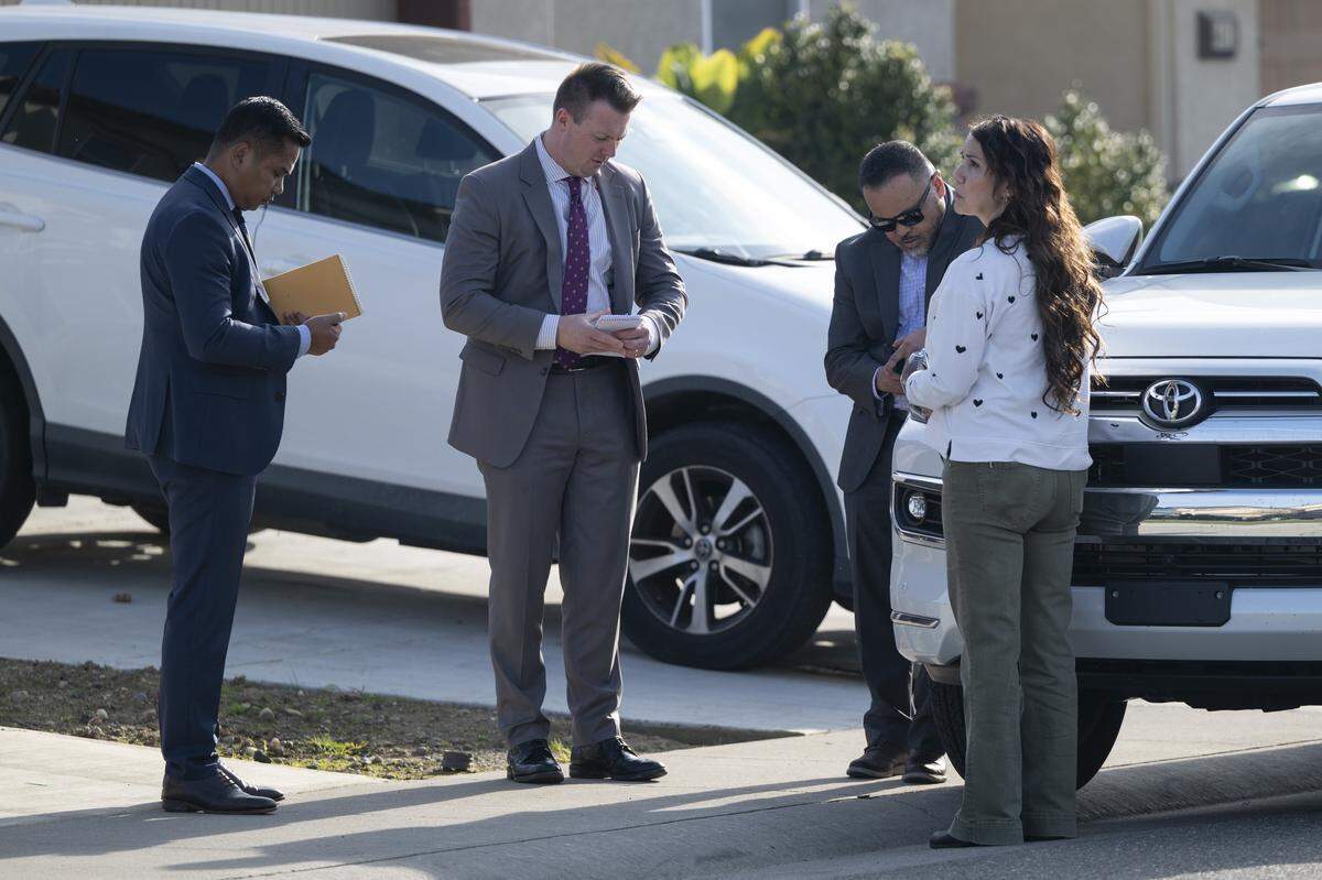 Law enforcement investigators talk near where four were found shot to death in Rancho Cordova on Tuesday.
