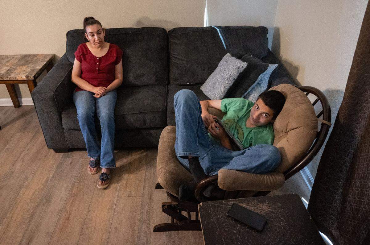Ana Soto sits with her son Max Moran Soto, 14, who is autistic and has ADHD, on Thursday, Aug. 24, at their home in Manteca.