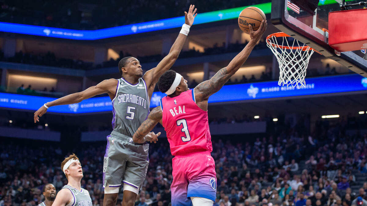 Washington Wizards guard Bradley Beal (3) makes a layup past Sacramento Kings guard De’Aaron Fox (5) during the first half in the NBA basketball game Friday.