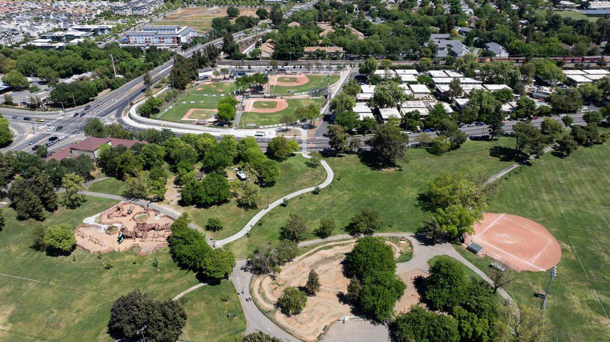 Davis residents enjoy Community Park while players practice on nearby Little League fields on Sunday, April 20, 2025, the weekend after a shooting at the park sent people across the area scrambling for cover.