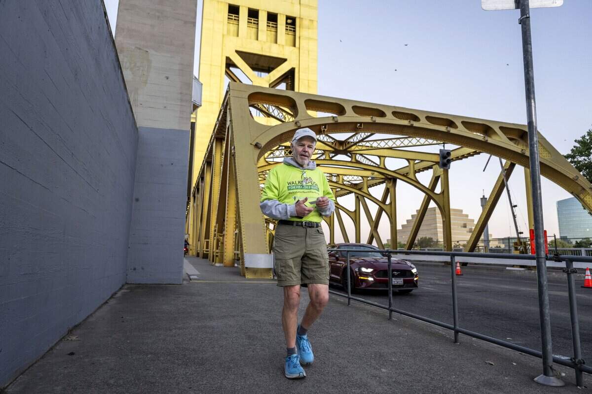 Dennis Godby of West Sacramento crosses the Tower Bridge as he walks to work earlier this month. He recently completed a five-stage, roughly 3,450-mile walk across the country to promote health equity.