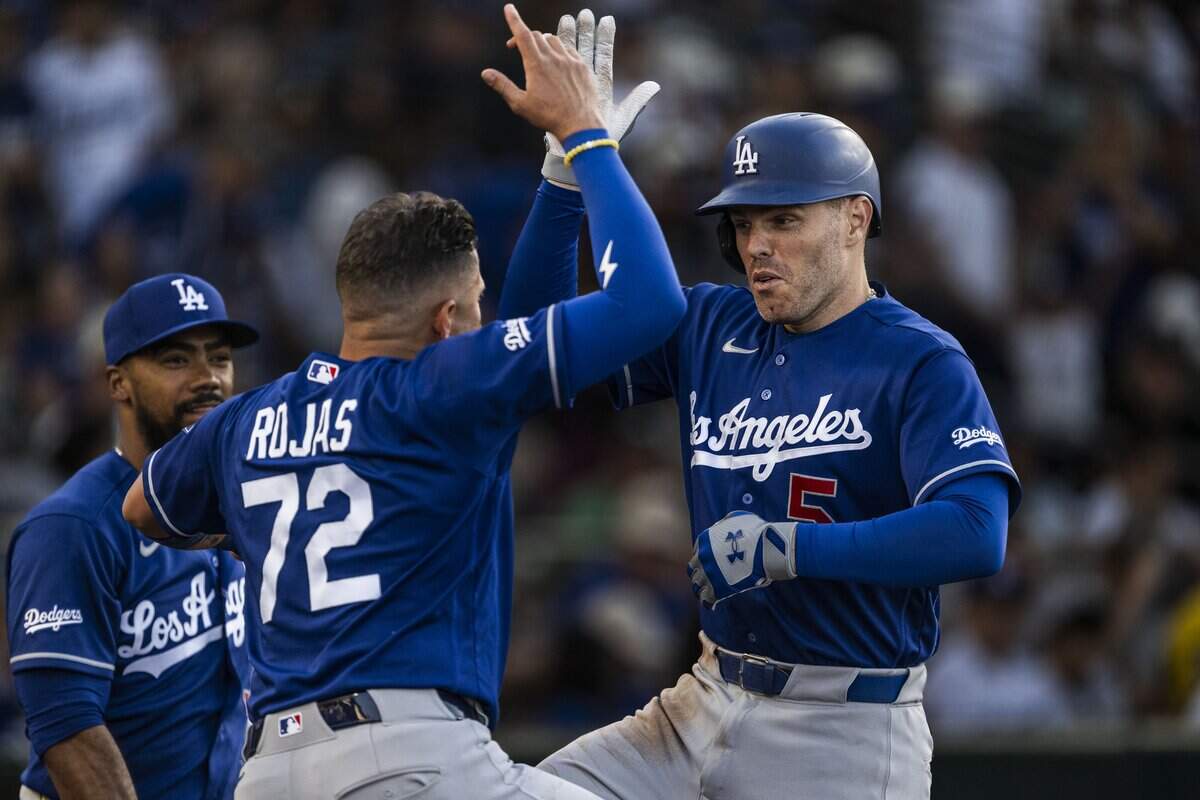 Los Angeles Dodgers infielder Miguel Rojas (72) celebrates a home run by teammate first baseman Freddie Freeman (5) against the Athletics at Sutter Health Park in West Sacramento on Wednesday.