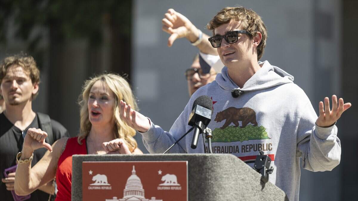 Online political influencer Nick Shirley speaks during a news conference in opposition to Assembly Bill 2624, which