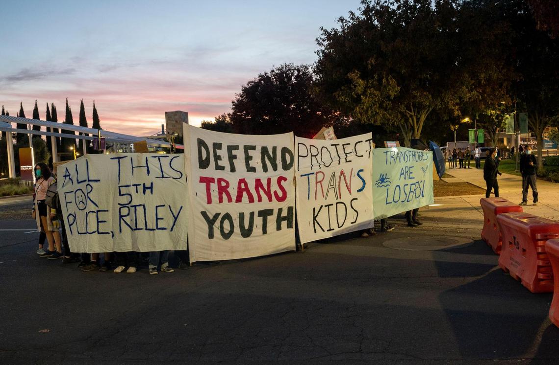 A group of protesters defending trans youth gather outside the conference centers at UC Davis as controversial speaker Riley Gaines, known for her outspoken views against&nbsp;trans-women in sports, prepares to speak Friday, Nov. 3, 2023, during her Speak Louder Campus Tour.