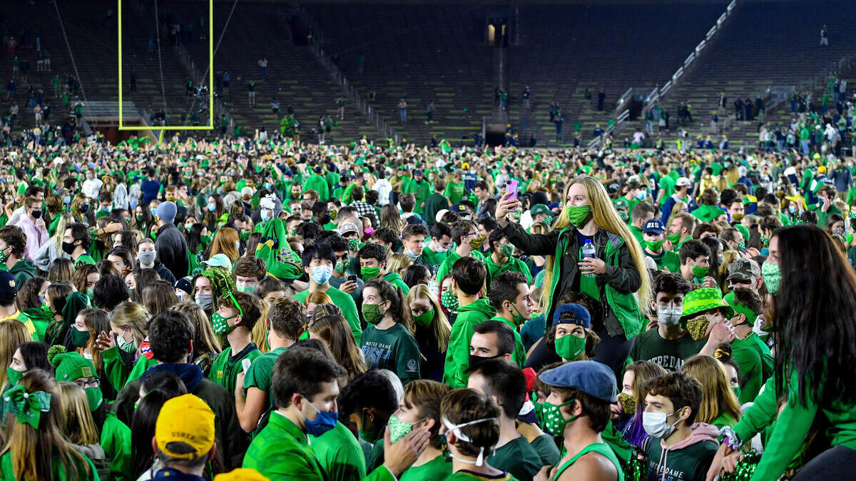 Fans storm the field after Notre Dame defeated the Clemson 47-40 Saturday.