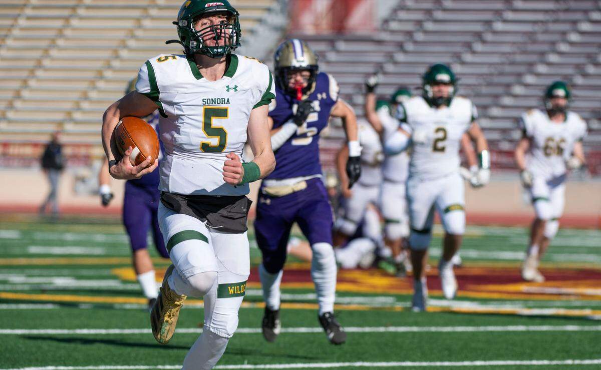 Sonora Wildcats quarterback Eli Ingalls (5) takes off for a 49-yard run on his team’s first play from scrimmage against the Bradshaw Christian Pride in the Sac-Joaquin Section Division VI championship game at Hughes Stadium in Sacramento on Friday, Nov. 29, 2024.