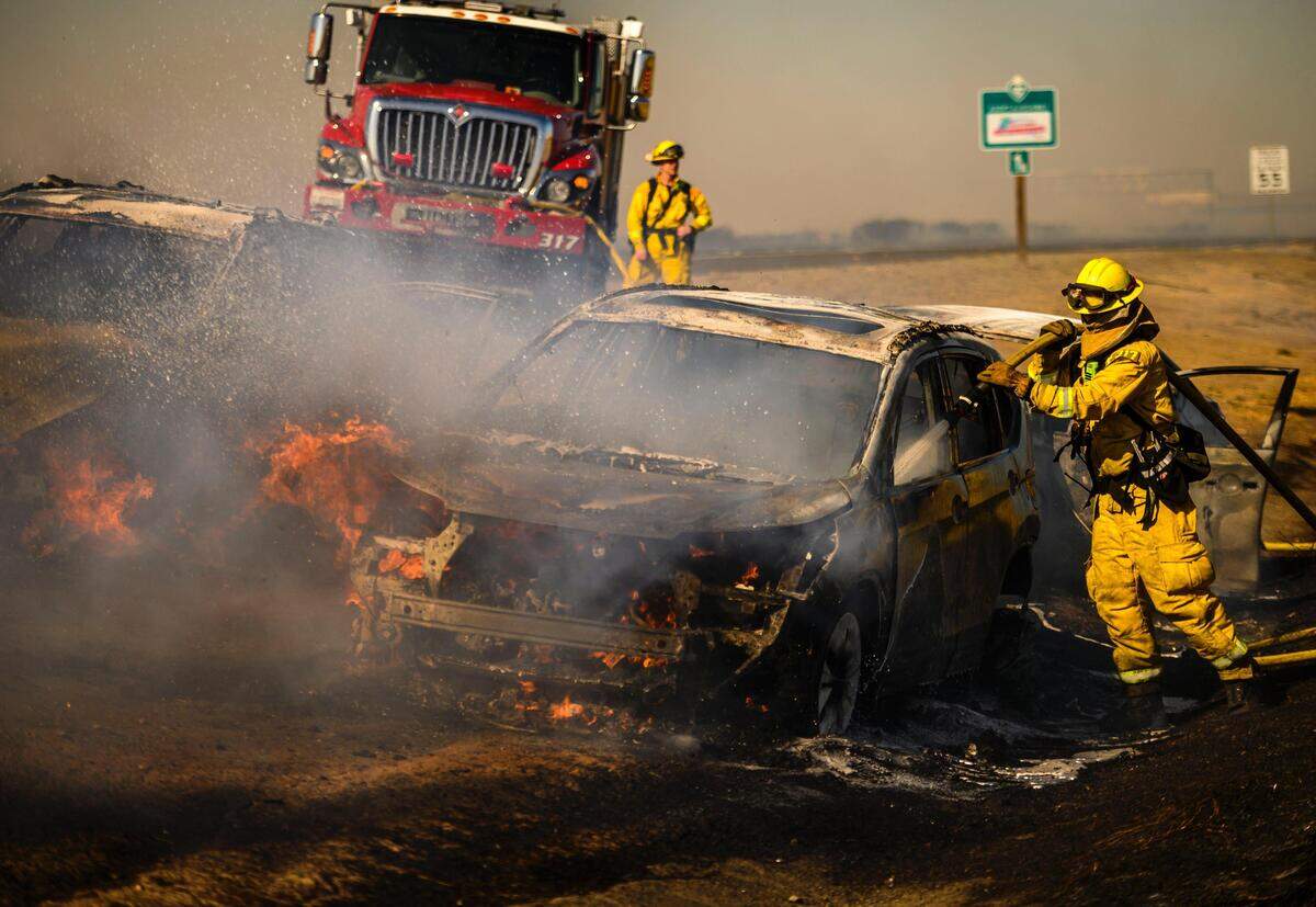 23. Sacramento City firefighters extinguish a burning a car on Interstate 5 in North Natomas on Sunday, Oct. 27, 2019.