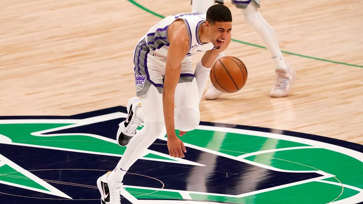 Sacramento Kings guard Tyrese Haliburton (0) loses control of the dribble and falls to the ground after suffering an unknown lower leg injury in the second half of an NBA basketball game against the Dallas Mavericks in Dallas, Sunday, May 2, 2021. (AP Photo/Tony Gutierrez)