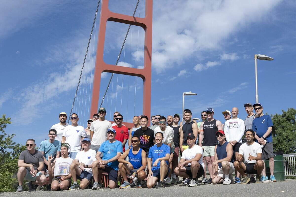 The Sacramento FrontRunners and FrontWalkers gather for their morning run at the Guy West Bridge along the American River Parkway in Sacramento on Saturday.