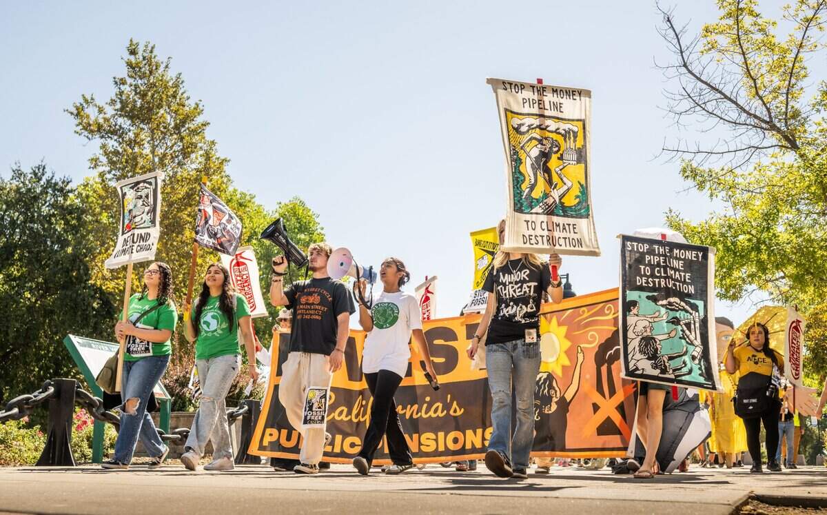 Granite Bay High School student Anushka Kalyan, 17, center, leads a march on Friday for youth climate action group Fridays for Future. The group wants the teachers’ pension fund to divest the $15 billion it has invested in fossil fuel companies.