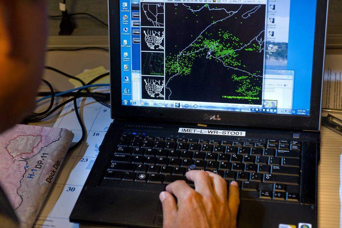 A National Weather Service meteorologist watches a record of lightning strikes at the Sacramento office in 2012. Once a hub for real-time storm monitoring across Northern California, the office now operates with reduced staffing and limited hours due to federal cutbacks.
