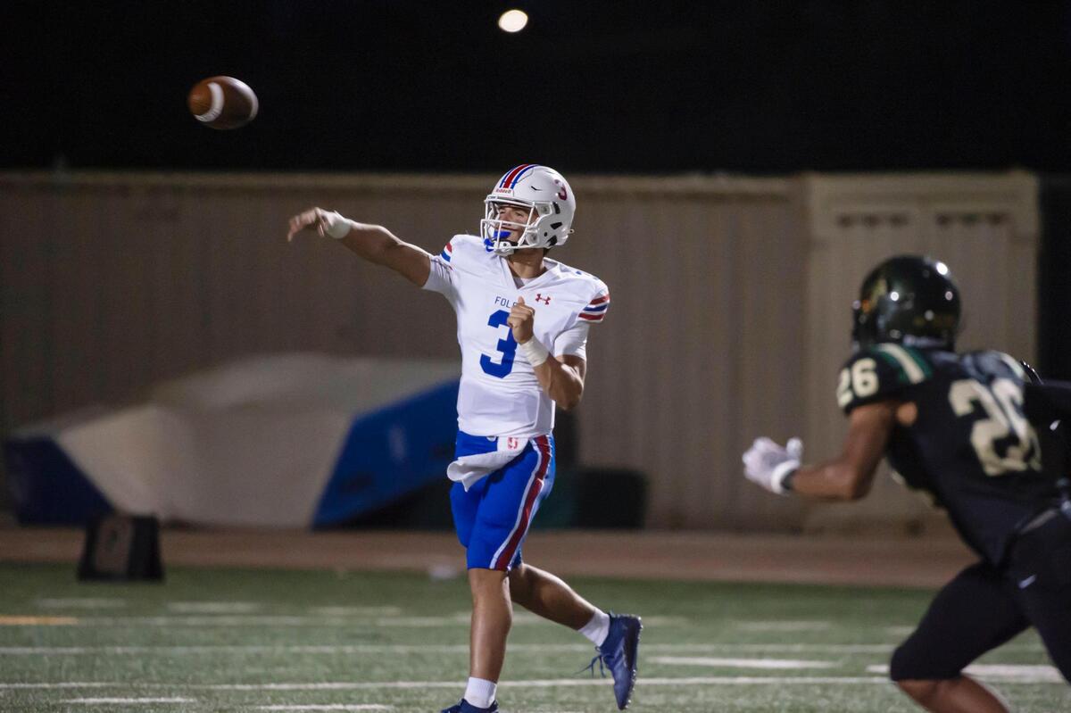 Folsom Bulldogs quarterback Ryder Lyons (3) passes as Monterey Trail Mustangs defender Donte Jacobs (26) puts pressure on him in the first half of their season opener Friday, Aug. 18, 2023, at Monterey Trail High School in Elk Grove.