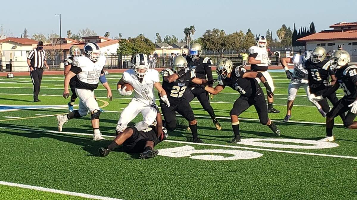 Casa Roble’s Dylan Overstreet spins away from Burbank defenders during a game Friday, April 9, 2021.