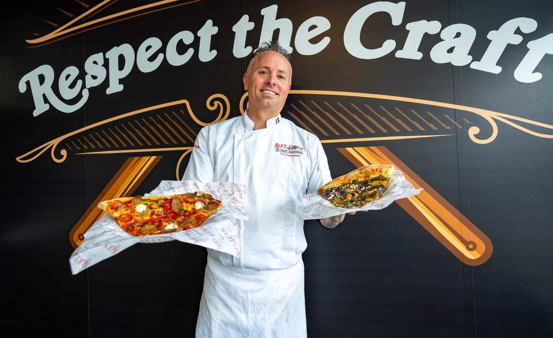 Tony Gemignani, Slice House franchise owner, holds a New York style pizza, left, and a Purple Potato pizza, right, on Thursday.