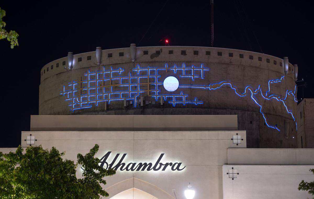 Michael Bishop’s art, a representation of the circular water tower surrounded by the Sacramento street grid&nbsp;and winding river and delta, lights up blue at night on the side of the immense concrete water tower behind the Alhambra Safeway, known as the Alhambra Reservoir.