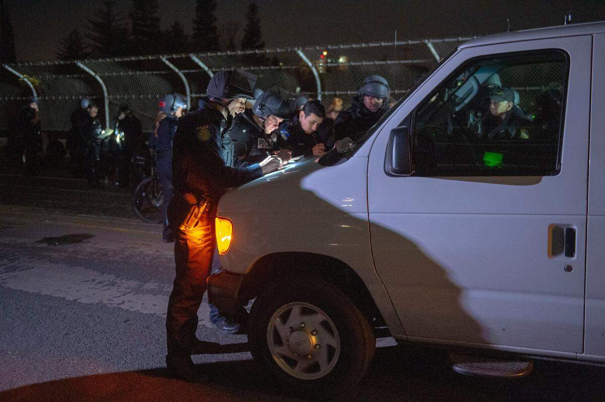Sacramento police officers complete paperwork for an arrest at the Stephon Clark march in East Sacramento on Monday, March 4, 2019. The march ended with more than 80 people arrested.